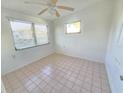 Simple bedroom with tiled floors and a ceiling fan at 1205 Gulf Blvd, Englewood, FL 34223