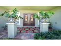 Inviting front entry with double doors and large potted plants at 13515 Keystone Blvd, Port Charlotte, FL 33981