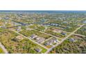 Aerial view highlighting a new three-unit home development at 14304 Amestoy Ave, Port Charlotte, FL 33981