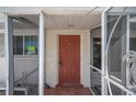 Front entrance with terracotta tile and screened porch at 1451 Deer Creek Dr, Englewood, FL 34223