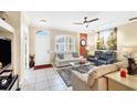 Living room with beige couches, a coffee table, and large artwork at 1985 Coconut Palm Cir, North Port, FL 34288