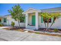 Charming home exterior with a teal front door at 268 Rotonda W Blvd # 1B, Rotonda West, FL 33947