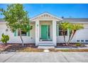 Inviting home exterior featuring a teal door and landscaping at 268 Rotonda W Blvd # 1B, Rotonda West, FL 33947