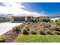 House exterior with a metal roof and landscaped front yard at 289 White Marsh Ln, Rotonda West, FL 33947