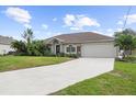 House exterior featuring a driveway and landscaping at 4145 Polynesia Rd, North Port, FL 34288