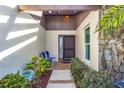 Inviting entryway with a brick path, and well-maintained landscaping at 618 Deerwood Ave, Englewood, FL 34223