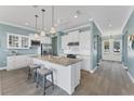 Modern kitchen featuring white cabinets, granite counters, and stainless steel appliances at 8025 Weyers Ct, Englewood, FL 34224