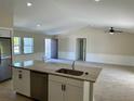 Kitchen island with granite countertop and stainless steel dishwasher at 9992 Antler St, Port Charlotte, FL 33981