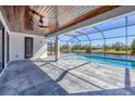 Screened-in pool and patio area with water views at 1097 Rotonda Cir, Rotonda West, FL 33947