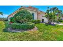Landscaped yard with lush greenery and manicured bushes at 12960 N Marsh Dr, Port Charlotte, FL 33953