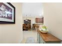 Hallway view with a glimpse of a dining area and kitchen at 13488 Abercrombie Dr, Englewood, FL 34223