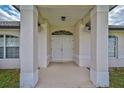 House entrance with double doors and covered porch at 209 Broadmoor Ln, Rotonda West, FL 33947