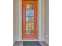 Attractive orange front door with a glass insert and decorative accents at 2148 La Palma Ave, Port Charlotte, FL 33953