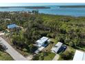 Wide aerial view of a waterfront property with multiple mobile homes at 2930 Waterside Dr, Englewood, FL 34224