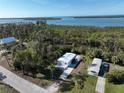 An aerial view showcasing a waterfront property featuring two mobile homes at 2930 Waterside Dr, Englewood, FL 34224