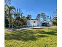 Single-wide mobile home with a shed and a large grassy yard at 2930 Waterside Dr, Englewood, FL 34224