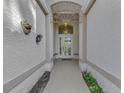 Elegant entryway with arched doorway and decorative wrought iron at 3300 Pennyroyal Rd, Port Charlotte, FL 33953