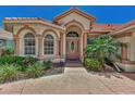 Front entrance with columns, arched windows and a tile roof at 3392 Pennyroyal Rd, Port Charlotte, FL 33953