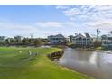 Golf course view with home and waterway in background at 10030 Eagle Preserve Dr, Englewood, FL 34224