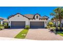 Two-car garage and paver driveway at 11249 Mc Dermott Ct, Englewood, FL 34223