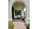 Relaxing front porch with wicker chairs and side table at 11249 Mc Dermott Ct, Englewood, FL 34223
