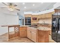 Large kitchen with an island, granite countertops, and stainless steel appliances at 2 Broadmoor Rd, Rotonda West, FL 33947