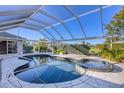 Relaxing kidney-shaped pool and spa with a screened enclosure at 2 Broadmoor Rd, Rotonda West, FL 33947