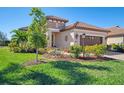 House exterior showcasing landscaping and a brick driveway at 26790 Weiskopf Dr, Englewood, FL 34223
