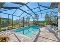 Relaxing screened-in pool with patio and seating area at 26790 Weiskopf Dr, Englewood, FL 34223