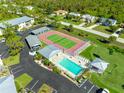 Complex overview showing pool, tennis courts, and building at 6600 Gasparilla Pines Blvd # 204, Englewood, FL 34224