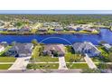 Aerial view of waterfront home with a large backyard and two-car garage at 6860 Pan American Blvd, North Port, FL 34287