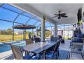 Covered patio with dining table next to the pool, ideal for outdoor entertaining at 9157 Genesee St, Port Charlotte, FL 33981
