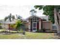 Exterior view of the house showing the front entrance and landscaping at 97 Mariner Ln, Rotonda West, FL 33947