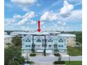 Two-story light teal townhome with attached garage and balcony at 10390 Longshore Rd # 82, Placida, FL 33946