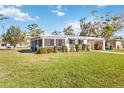 White single story home with green lawn and carport at 1305 Rocky Creek Ln, Englewood, FL 34224