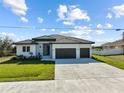 Single story home with a three car garage and neutral color scheme at 14681 Keystone Blvd, Port Charlotte, FL 33981