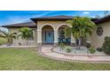 Covered porch with seating area, palm trees and walkway at 166 Rotonda N Blvd, Rotonda West, FL 33947