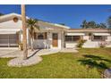 Front entrance of a ranch style home with walkway and landscaping at 1780 Elinor Pl, Englewood, FL 34223