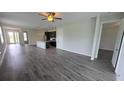 Open living room and kitchen with wood-look tile floors at 30072 Alder Rd, Punta Gorda, FL 33982