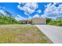 Charming single-story home featuring a two-car garage and well-maintained front yard at 4036 Elvington Rd, Port Charlotte, FL 33981