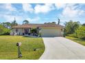 Single-story house with a landscaped yard and festive decorations at 4036 Elvington Rd, Port Charlotte, FL 33981