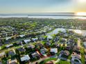 Aerial perspective of a house in a residential neighborhood near the water at 455 Firethorn Ave, Englewood, FL 34223