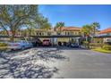 Condo building with covered parking and mature trees at 520 Pine Hollow Cir # 520, Englewood, FL 34223