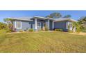 Single-story home with a metal roof and a modern design at 6096 Bowie Ln, Englewood, FL 34224