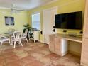 Bright dining area with table, chairs, and access to kitchen at 72 Boundary Blvd # 229, Rotonda West, FL 33947