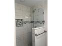 Modern shower with glass enclosure and gray marble tile at 7320 Freeberg Cir, Port Charlotte, FL 33981