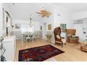 Bright living room with hardwood floors and wicker furniture at 9457 Heartwellville Ave, Englewood, FL 34224