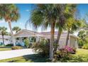 Beautiful home with lush landscaping and palm trees at 9487 Prospect Ave, Englewood, FL 34224