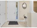 Bright entryway with a white door and decorative bird statue at 109 Bonita Dr, Rotonda West, FL 33947
