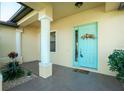Inviting entryway with a light teal door and decorative wreath at 109 Bonita Dr, Rotonda West, FL 33947